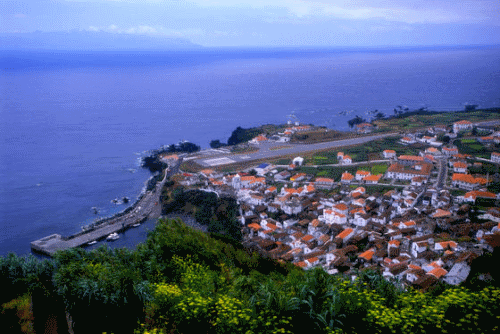 a view of Vila Nova do Corvo and Flores Island in the background